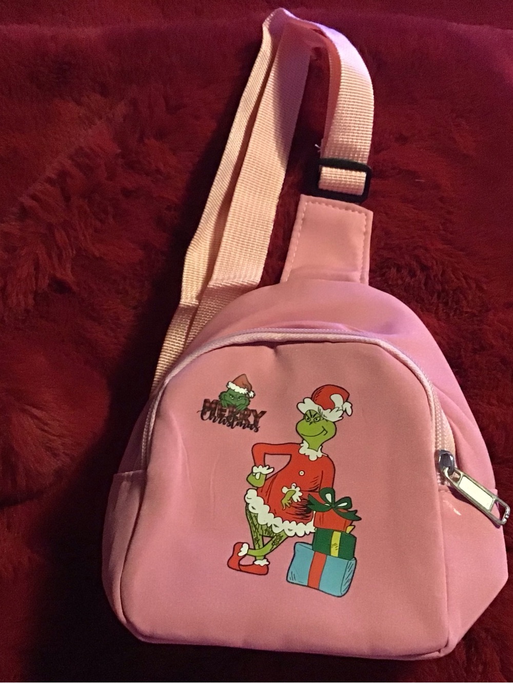 Pink crossbody bag with Grinch design
